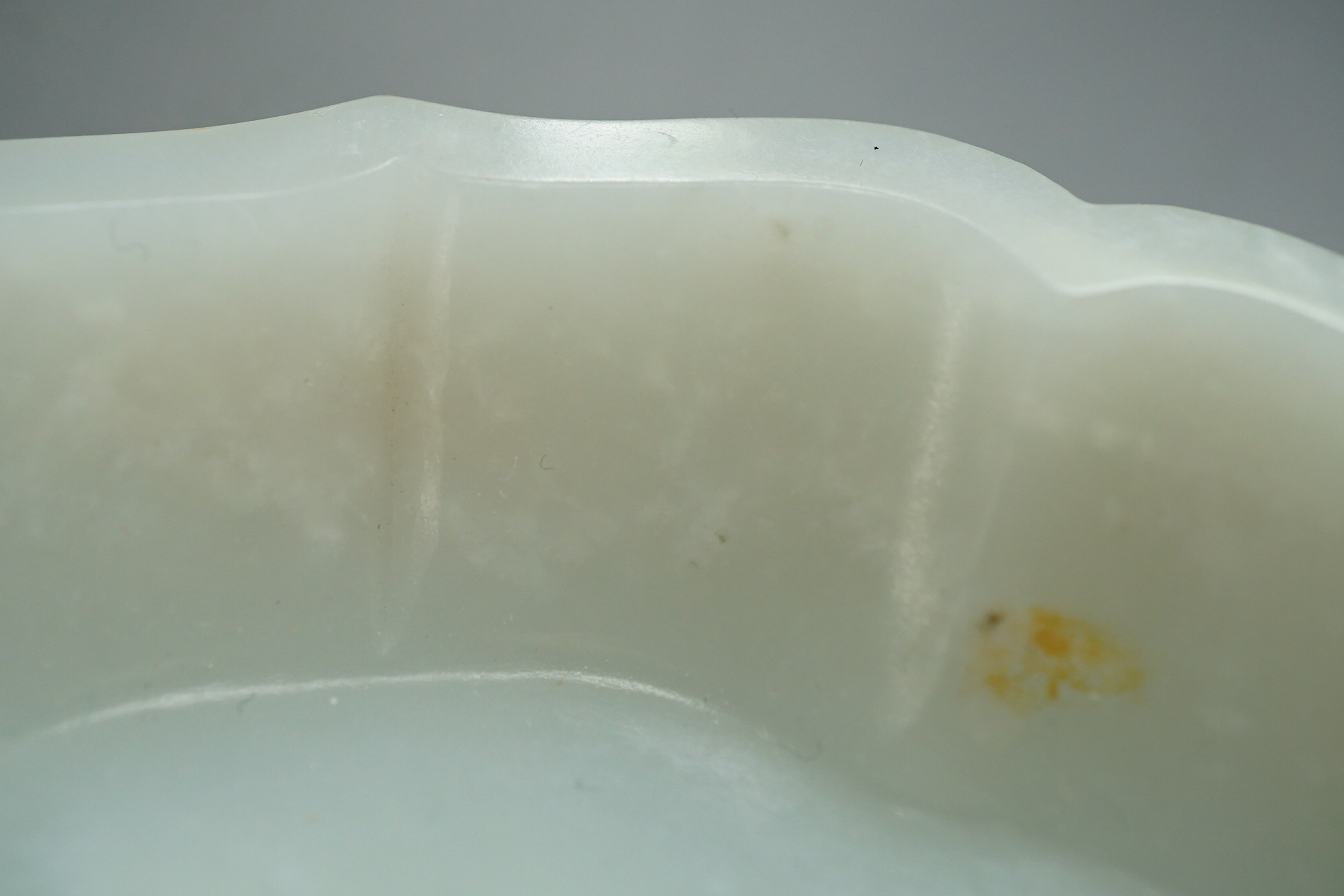 A Chinese white and russet jade petal lobed cup stand